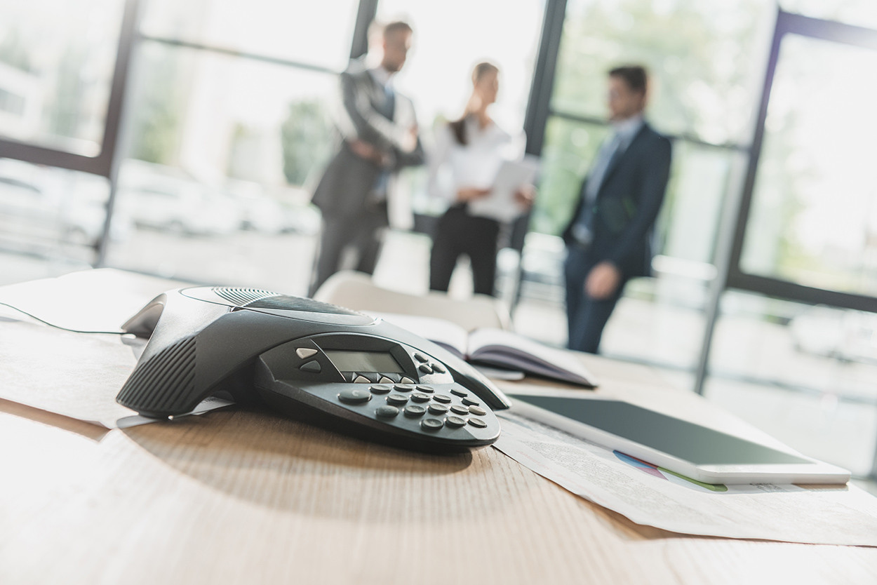 close-up-shot-of-conference-phone-with-blurred-bus-2023-11-27-05-21-57-utc